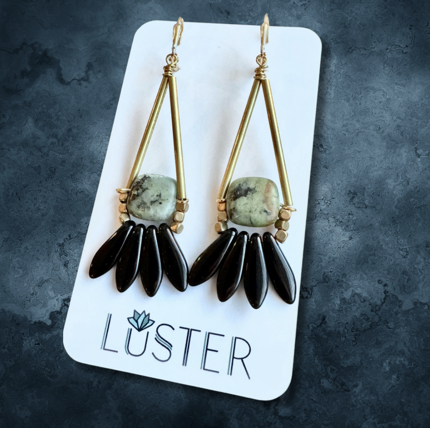 stone statement brass earrings on branded card