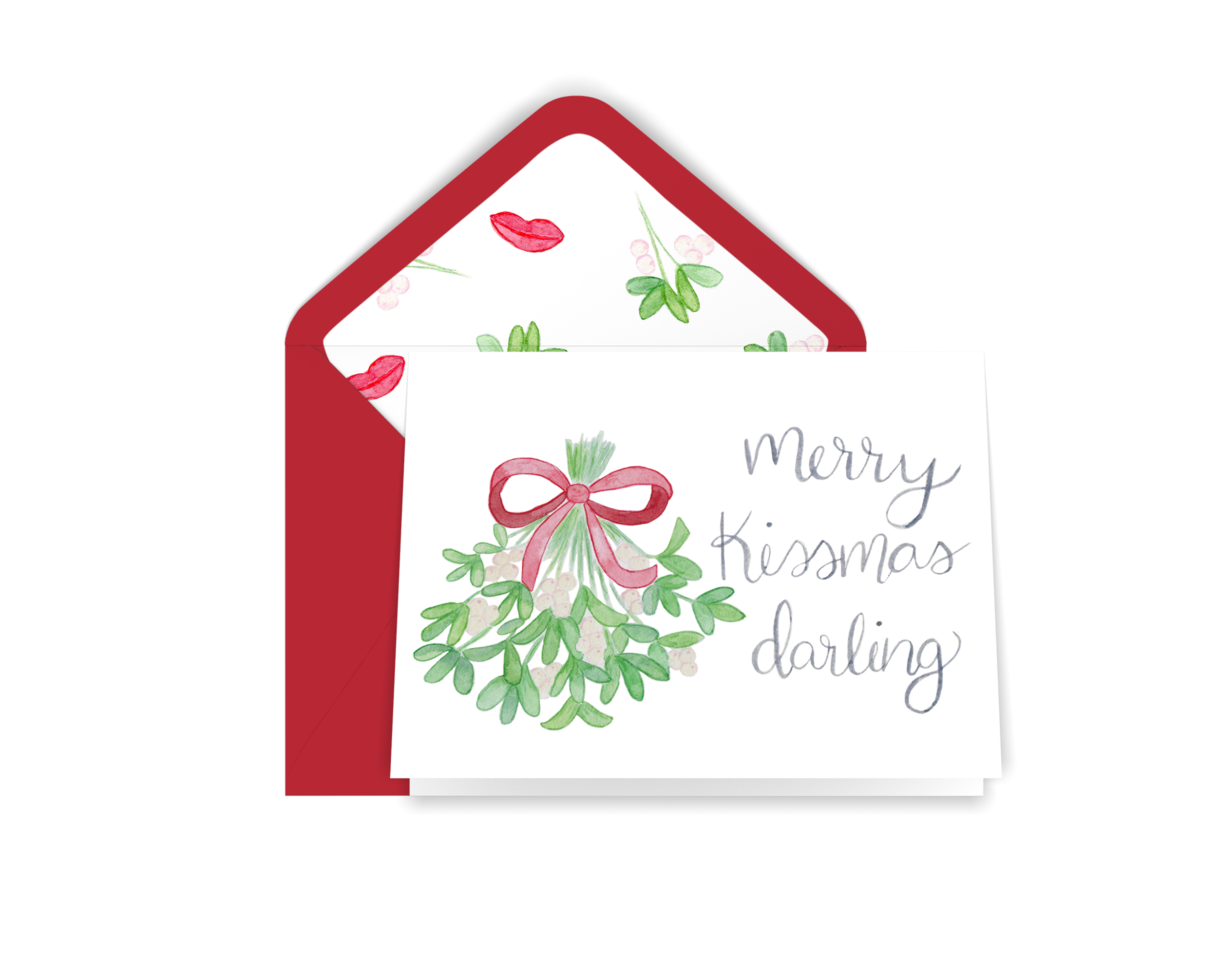 Our card features our watercolor painting of mistletoe tied with a red ribbon and iridescent berries next to the words “Merry Kissmas Darling” in our signature calligraphy. Comes with a red envelope.