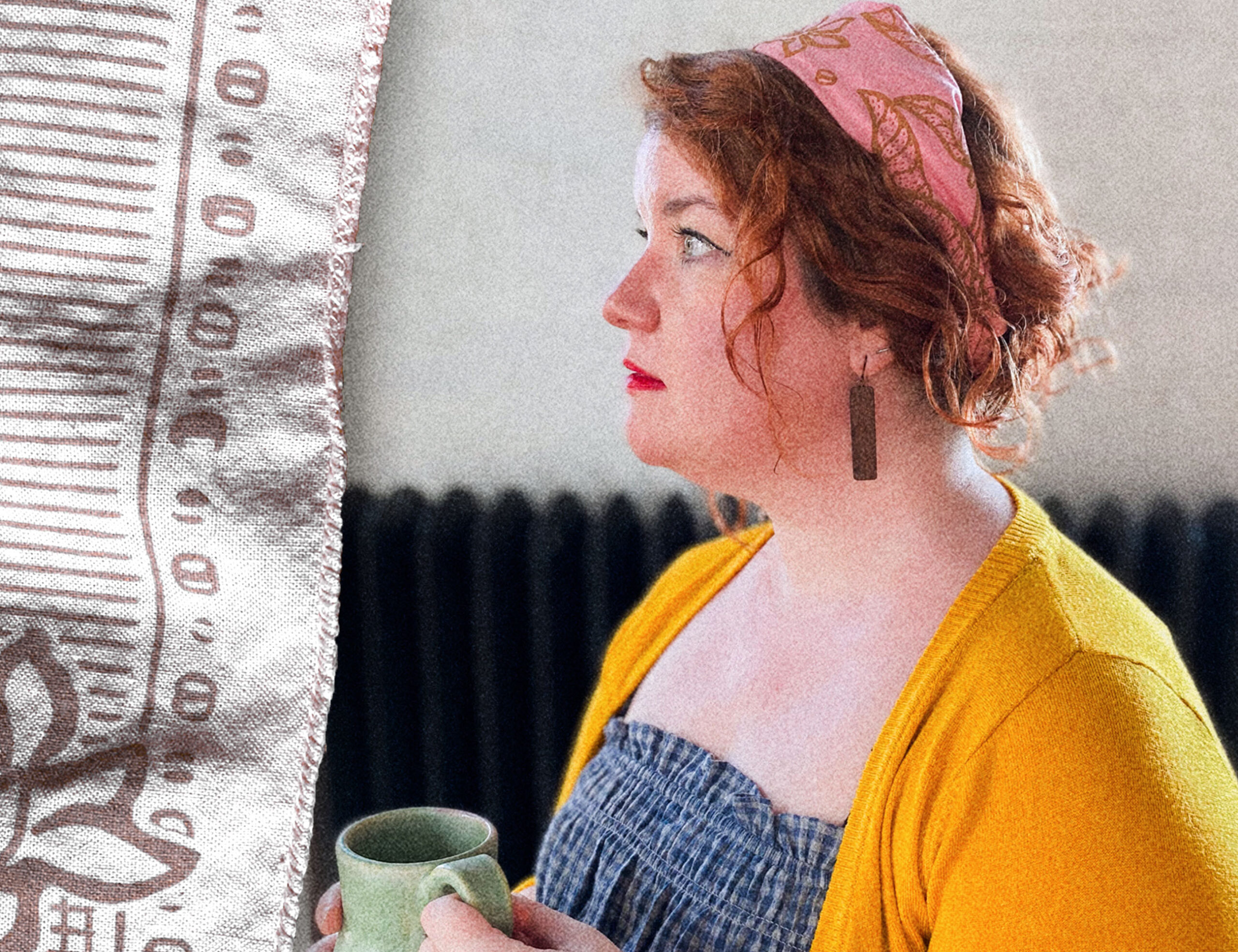 woman with gorgeous, curly red hair, pulled into an updo with a pink, banned books & coffee nooks sugar camp bandana, stares into the distance while holding a cup of coffee.