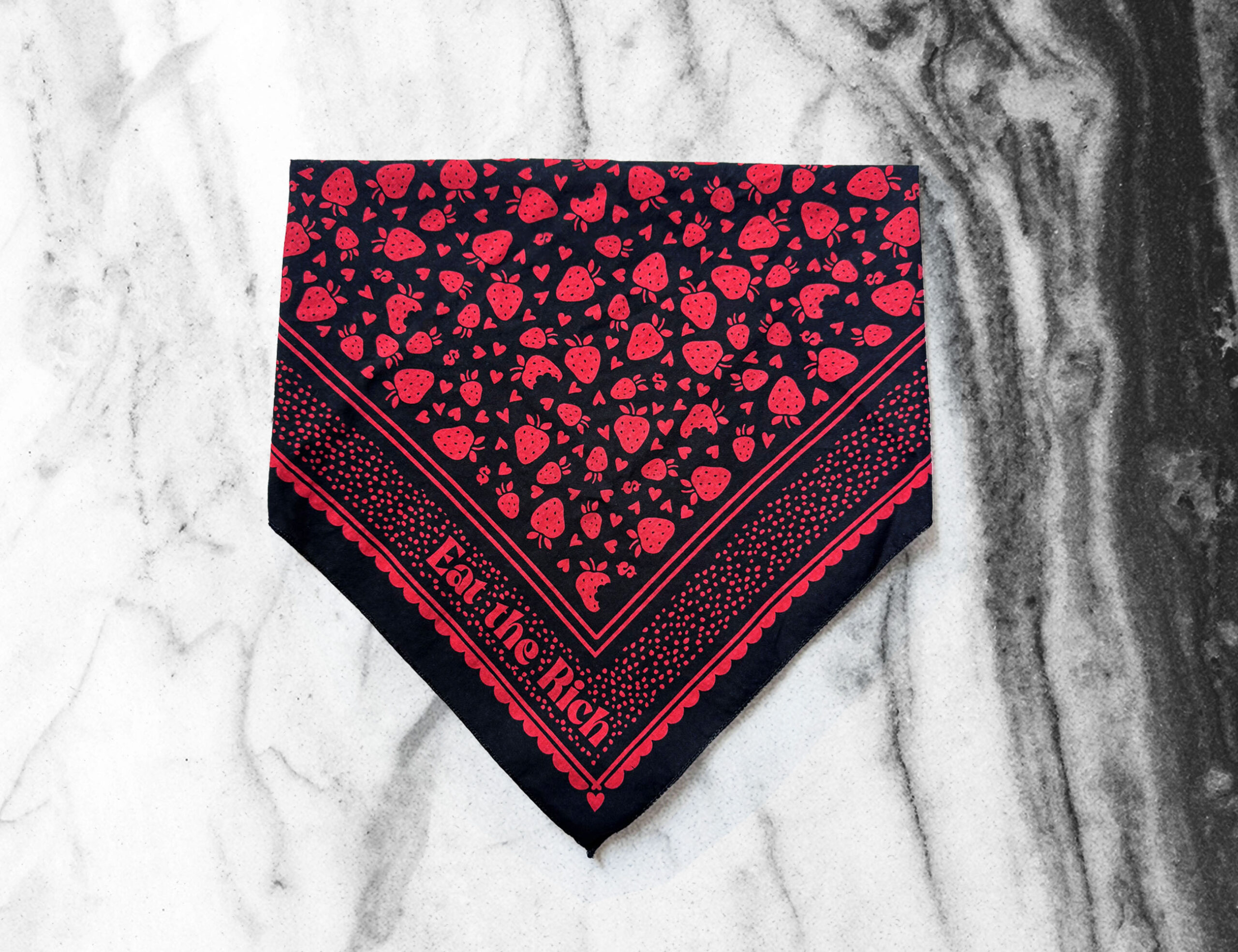 Cream “Eat the Rich” bandana with red strawberry, heart, and dollar sign print on white marble background