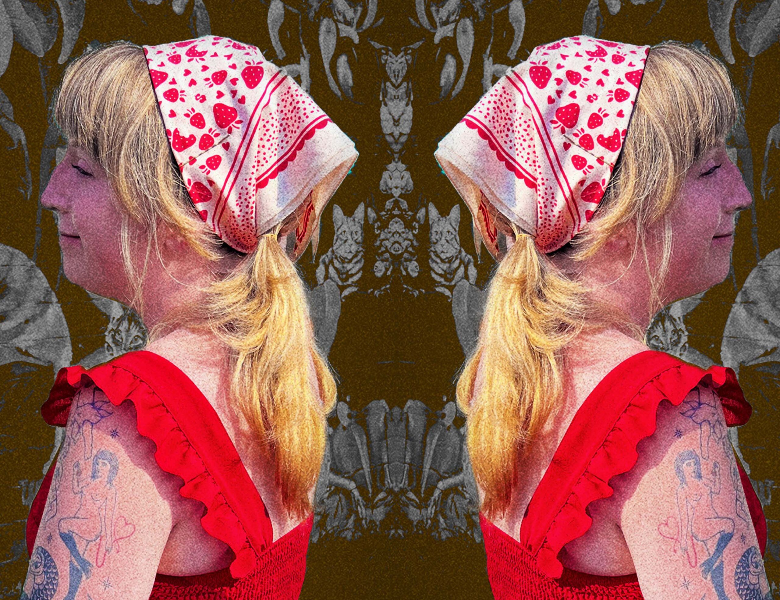 Mirrored image of The side of a young blonde woman in a frilly red dress wearing an Eat the Rich Sugar Camp cream bandana with strawberries on it.