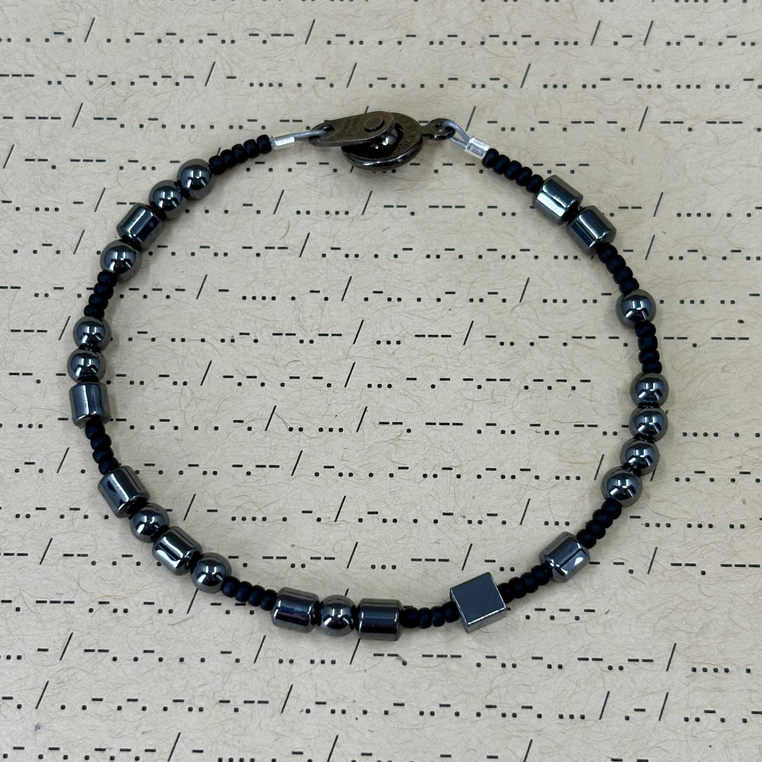 "Fuck Them" Morse Code Bracelet made with hematite and glass beads.