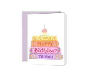 Greeting card with illustrated stack of books in soft colors with words "wishing you a happy birthday" and a cupcake on top.