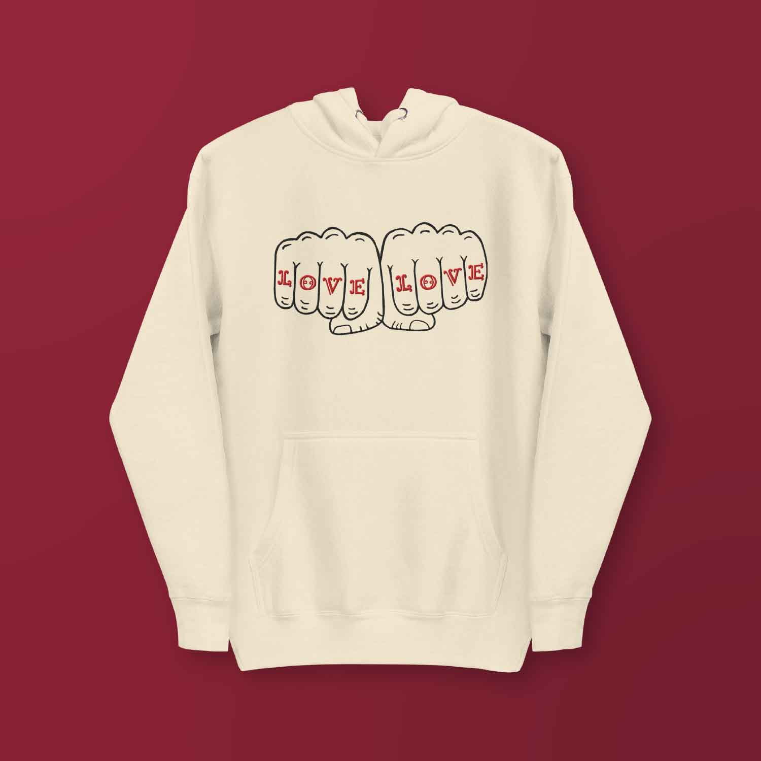 A cream hoodie with a design that reads LOVE LOVE