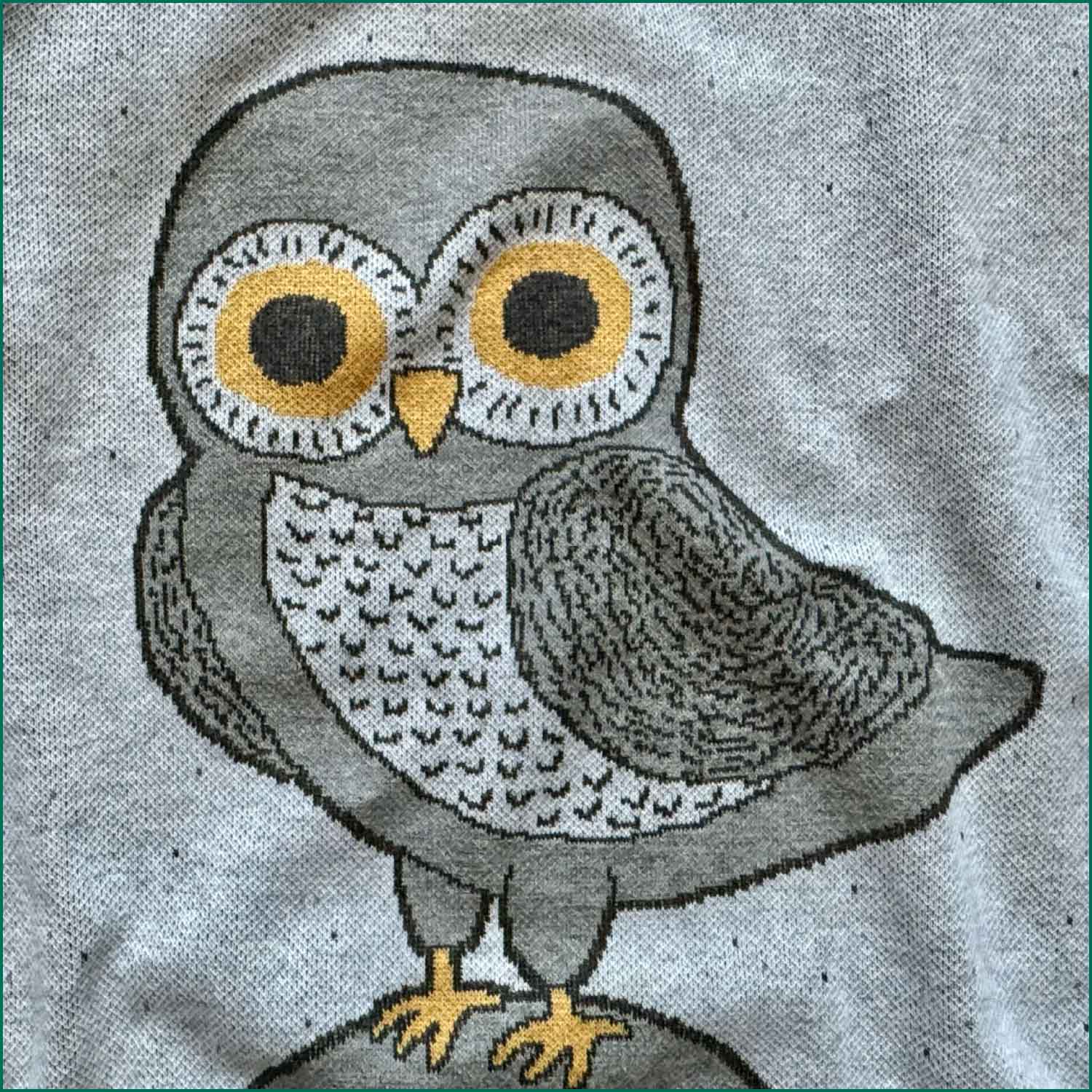 Close up knit detail of a gray owl