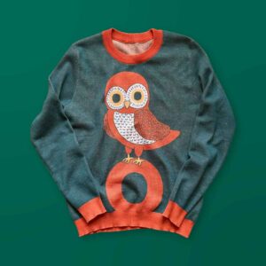A green sweater with an orange owl design on the front