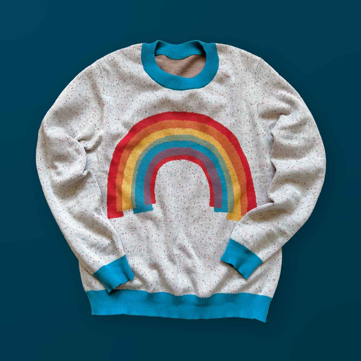 A white sweater with a rainbow design