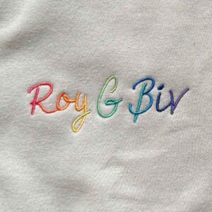 Closeup of embroidery detail that says Roy G Biv in a rainbow of color