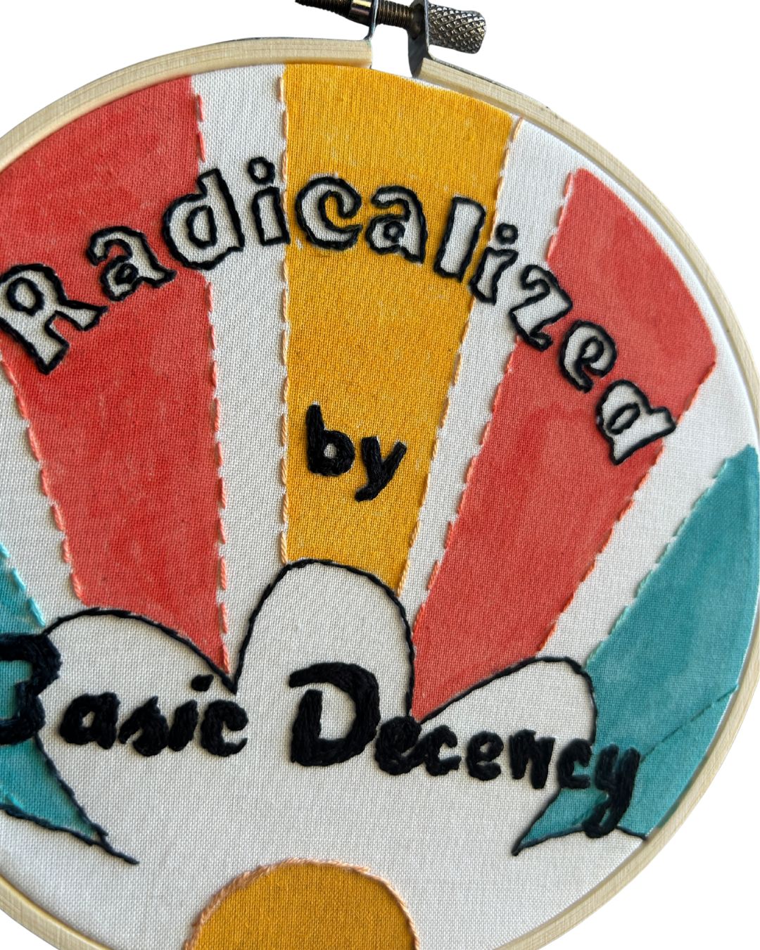 Hand embroidery that says "radicalized by basic decency" with a retro pattern