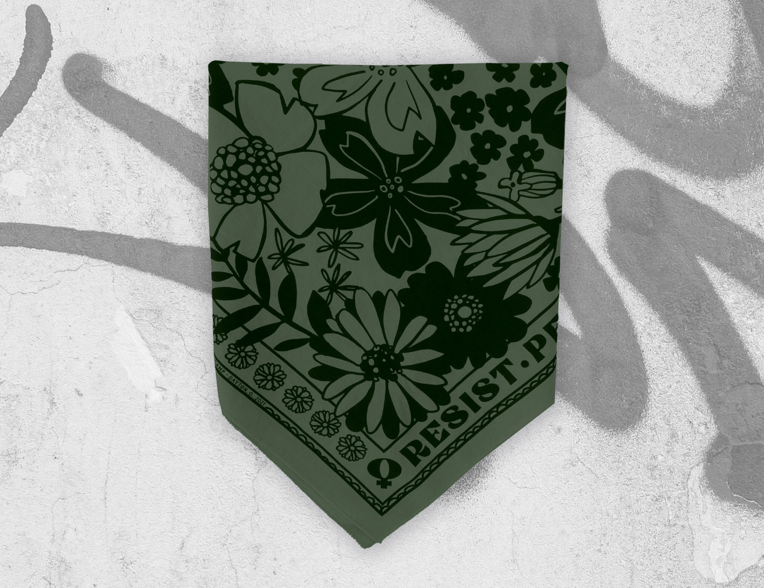 sugar camp resist persist dissent bandana in pine green folded into partial triangle on graphiti background