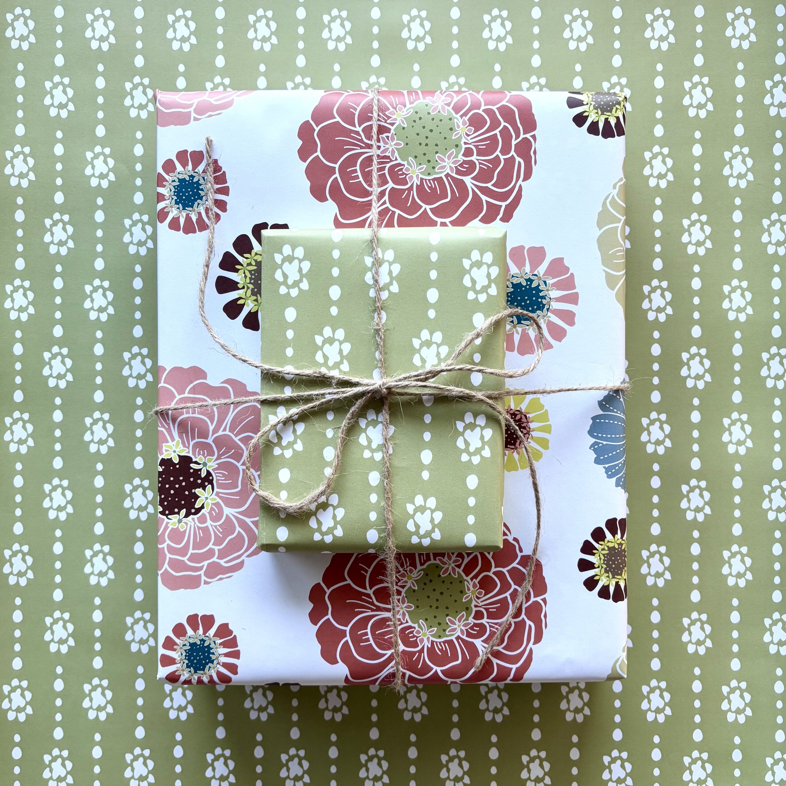 Two gift boxes with coordinating prints, one a colorful zinnia floral, the other an organic dot stripe on a green background